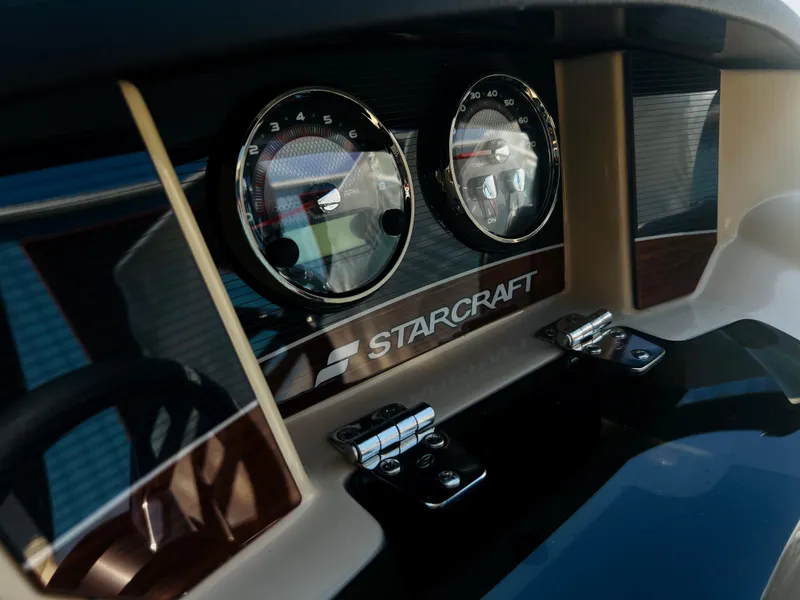 Slide: The Image of Luxurious cockpit of 2026 Starcraft RX 23 R DC boat with modern steering and controls. - 14