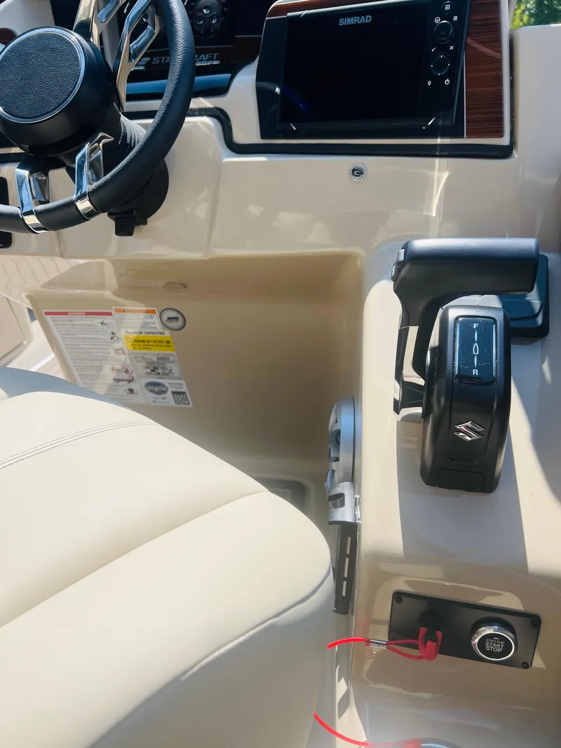 Slide: The Image of 2026 Starcraft RX 23 R DC boat interior with steering wheel and control panel. - 15