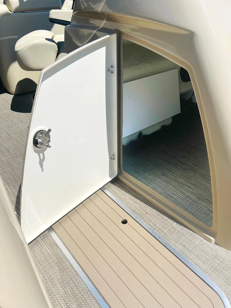 Slide: The Image of 2026 Starcraft RX 23 R DC boat dashboard with steering wheel and controls. - 17