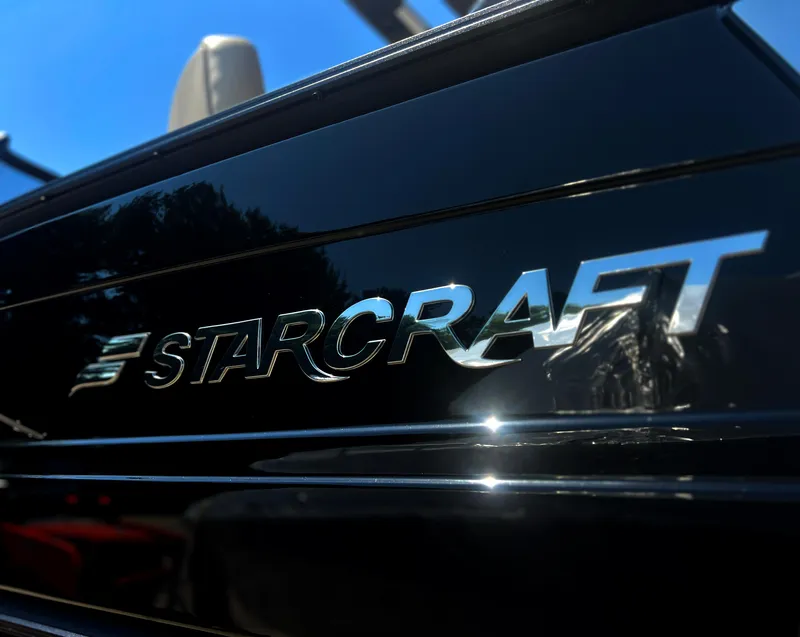 Slide: The Image of Open storage compartment in 2026 Starcraft RX 23 R DC boat seat. - 21