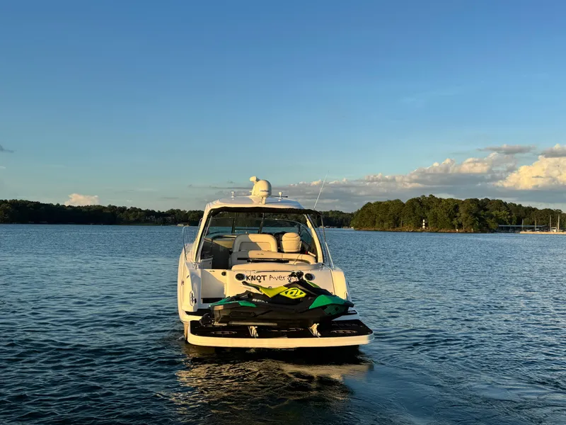 Slide: The Image of 2005 Sea Ray 420 Sundancer yacht on calm water at sunset. - 11