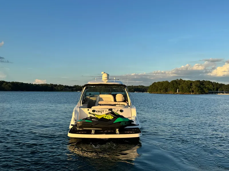 Slide: The Image of 2005 Sea Ray 420 Sundancer yacht on calm water at sunset. - 12