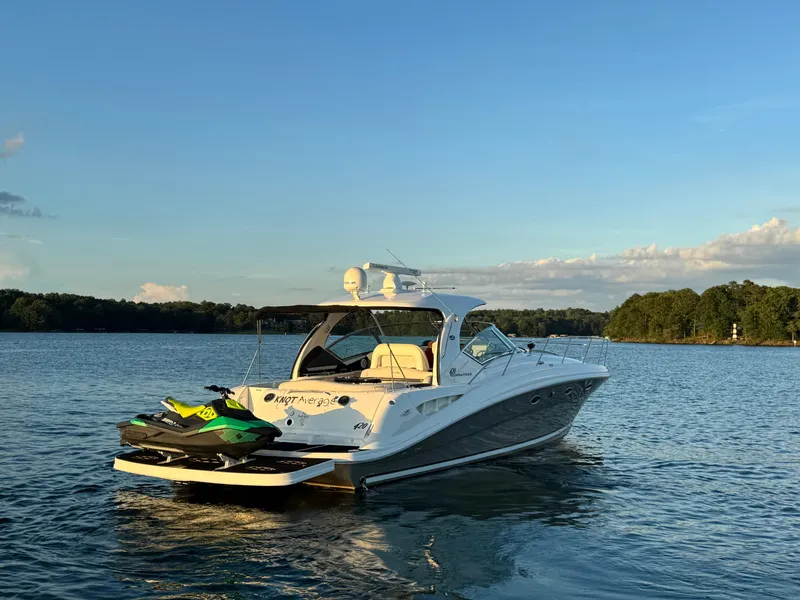 Slide: The Image of 2005 Sea Ray 420 Sundancer yacht on calm water at sunset with jet ski. - 15