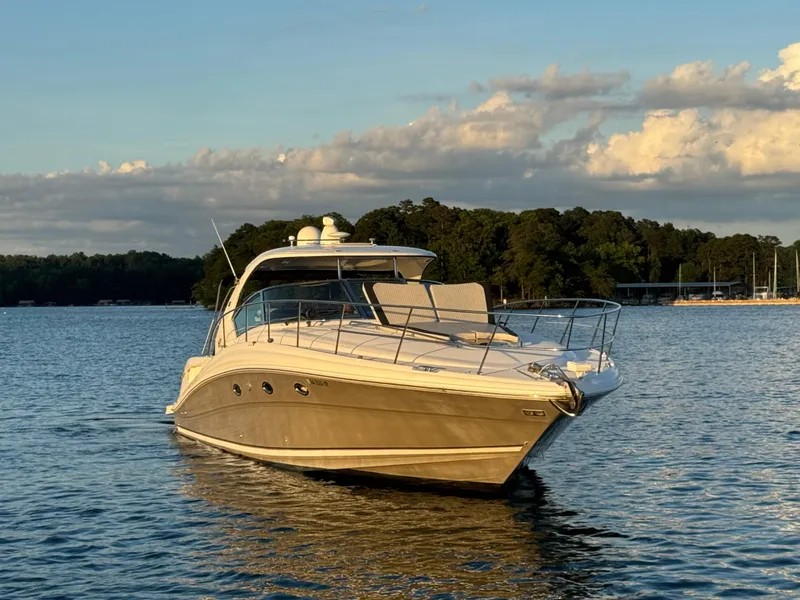 Slide: The Image of 2005 Sea Ray 420 Sundancer yacht on serene lake at sunset. - 19