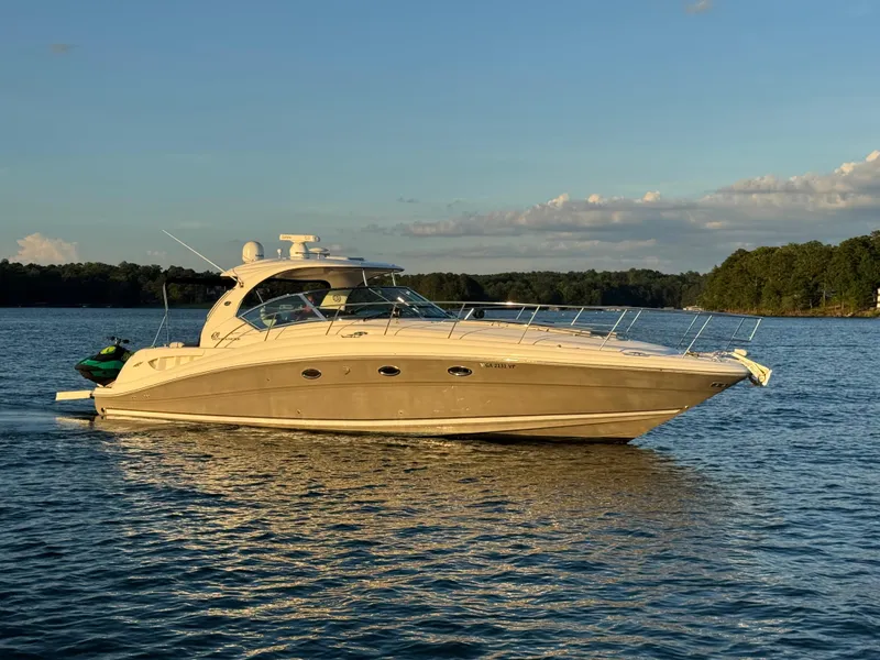 Slide: The Image of 2005 Sea Ray 420 Sundancer yacht on calm water at sunset. - 2