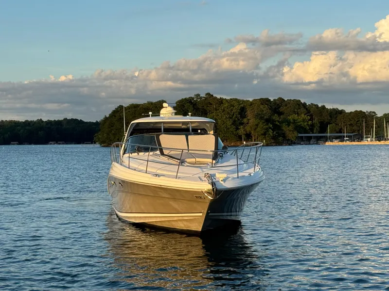 Slide: The Image of 2005 Sea Ray 420 Sundancer yacht on a serene lake at sunset. - 20