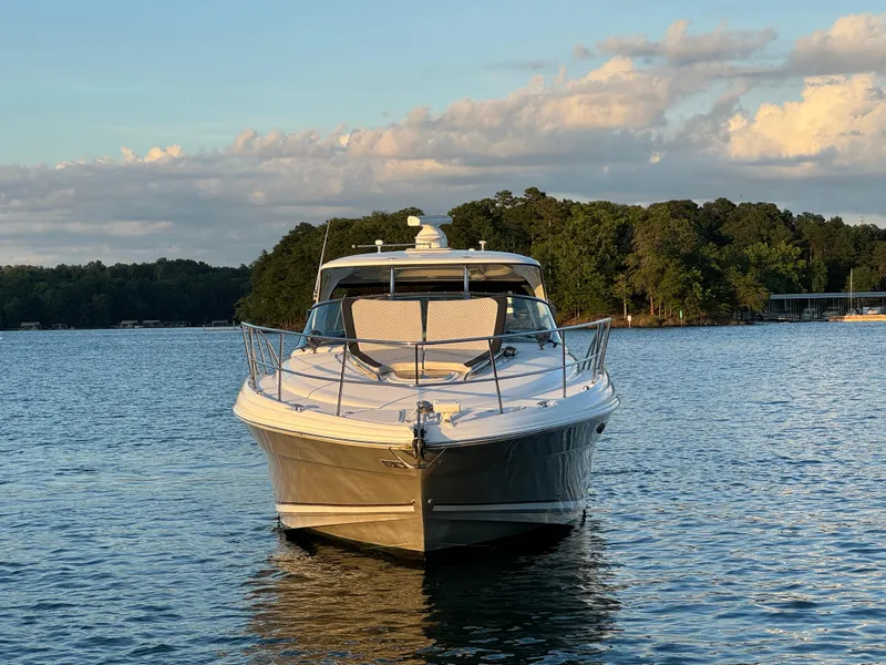 Slide: The Image of 2005 Sea Ray 420 Sundancer yacht on a serene lake at sunset. - 21