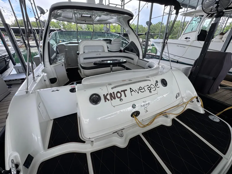 Slide: The Image of 2005 Sea Ray 420 Sundancer yacht docked, featuring spacious seating and "Knot Average" name. - 23