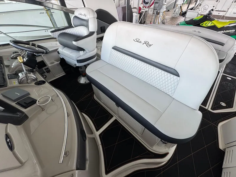 Slide: The Image of 2005 Sea Ray 420 Sundancer cockpit with luxurious seating and helm controls. - 27