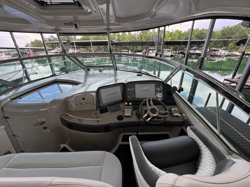Slide: The Image of 2005 Sea Ray 420 Sundancer helm with Garmin navigation, docked at marina. - 28