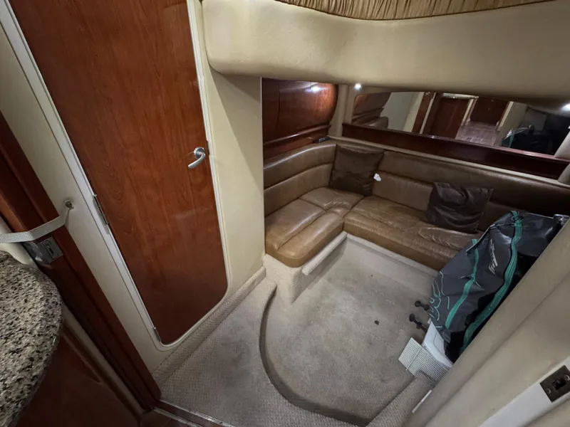 Slide: The Image of Interior of 2005 Sea Ray 420 Sundancer with leather seating and wooden accents. - 33