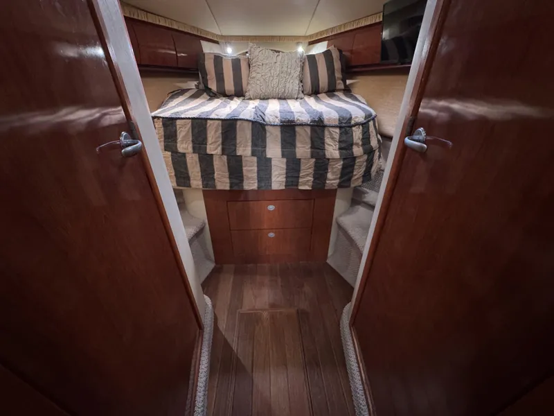 Slide: The Image of Luxurious cabin interior of 2005 Sea Ray 420 Sundancer yacht with striped bedding. - 34