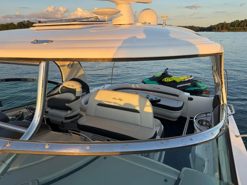 Slide: The Image of 2005 Sea Ray 420 Sundancer yacht with jet ski on calm water at sunset. - 36