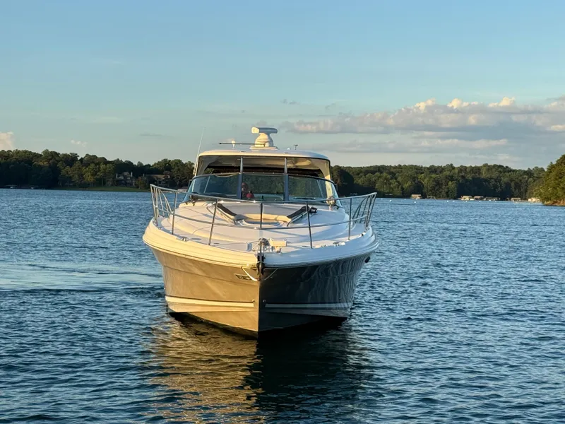 Slide: The Image of 2005 Sea Ray 420 Sundancer yacht cruising on a serene lake at sunset. - 5