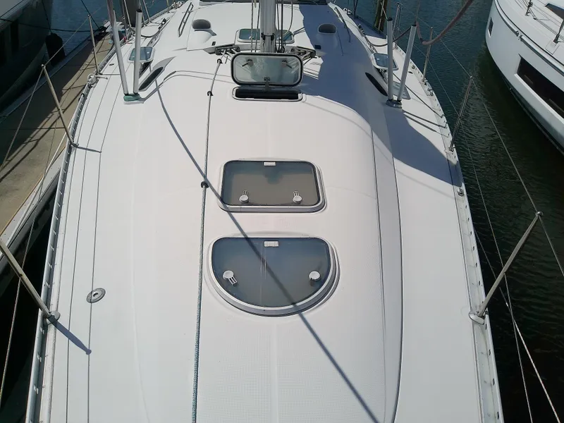 Slide: The Image of Deck view of a 1995 Beneteau First 42s7 sailboat with hatches and rigging. - 12