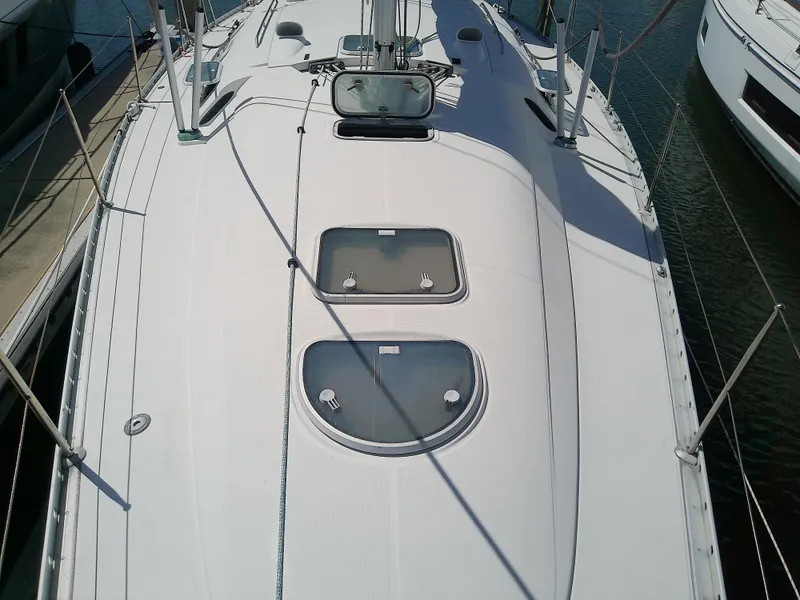 Slide: The Image of 1995 Beneteau First 42s7 yacht deck with hatches, docked in marina. - 13