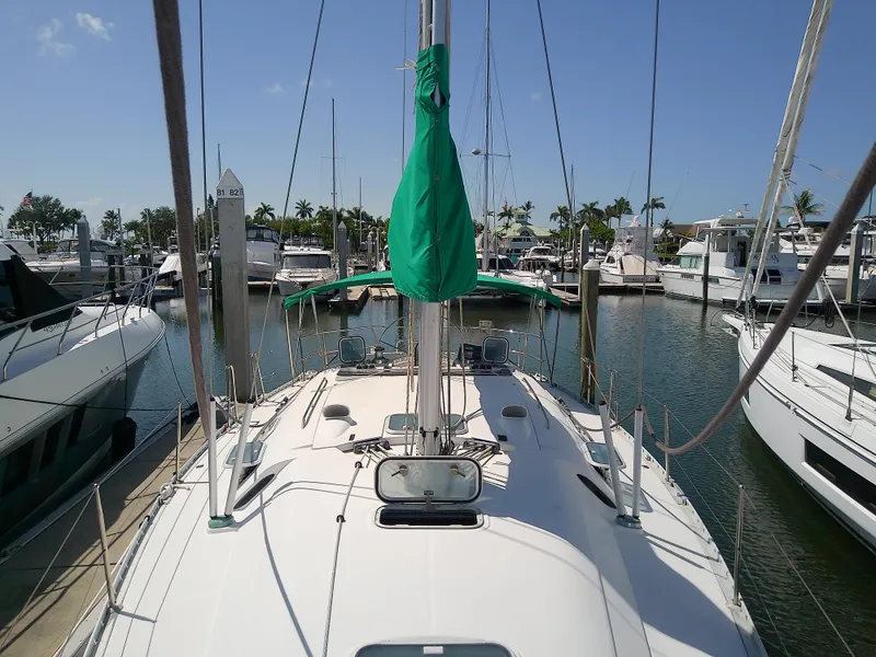 Slide: The Image of Sailboat Beneteau First 42s7, 1995 model, docked in a sunny marina. - 15