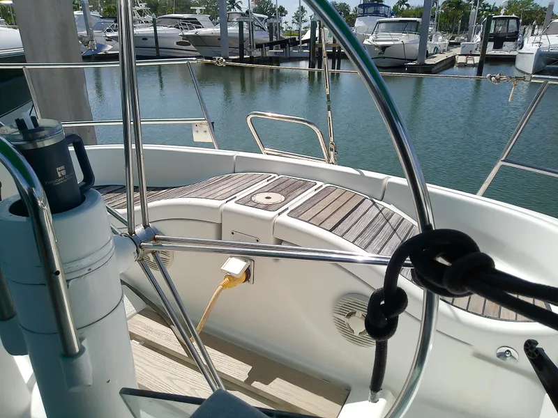 Slide: The Image of Cockpit view of a 1995 Beneteau First 42s7 sailboat docked at a marina. - 17