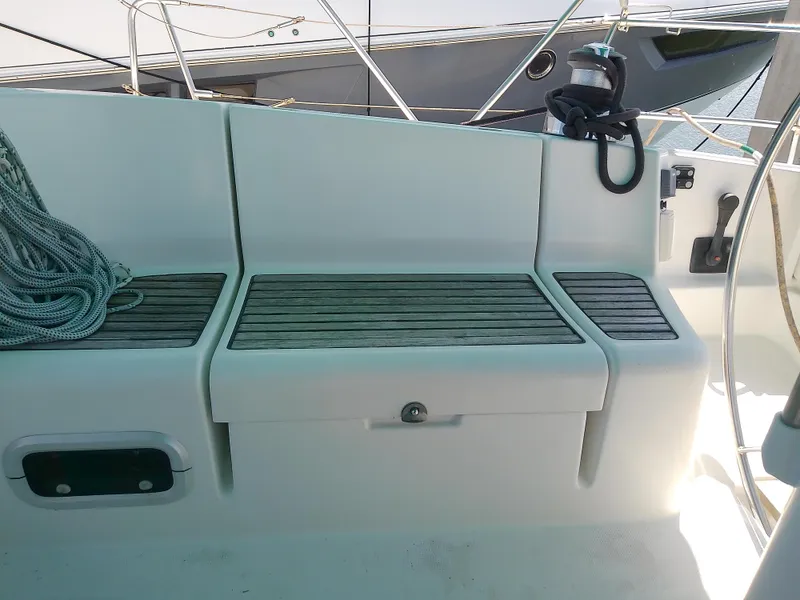 Slide: The Image of Cockpit seating of 1995 Beneteau First 42s7 sailboat with wooden slats and rope. - 18