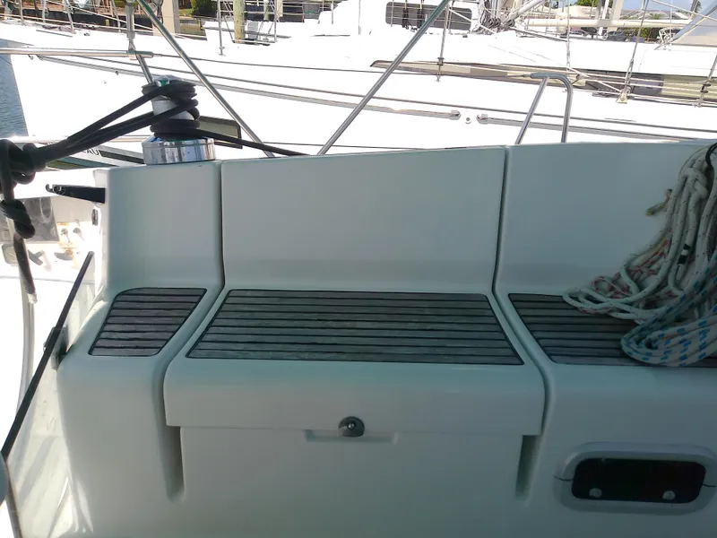 Slide: The Image of Cockpit seating area of a 1995 Beneteau First 42s7 sailboat with ropes and winch. - 19
