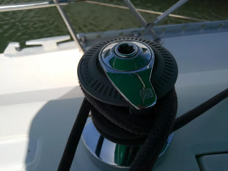 Slide: The Image of Winch on 1995 Beneteau First 42s7 sailboat deck, with rope coiled around. - 22