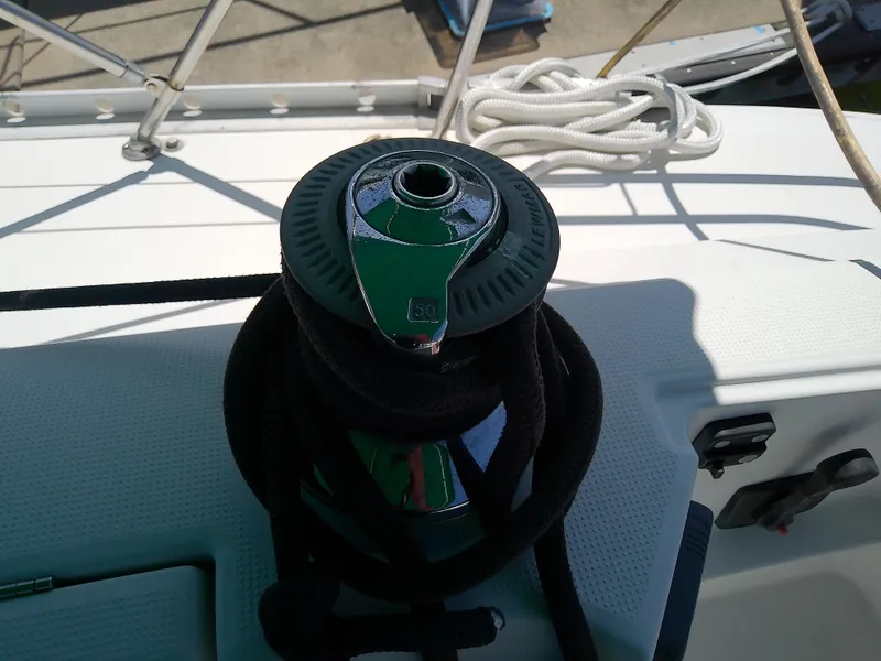 Slide: The Image of Winch on 1995 Beneteau First 42s7 sailboat deck with coiled rope. - 23