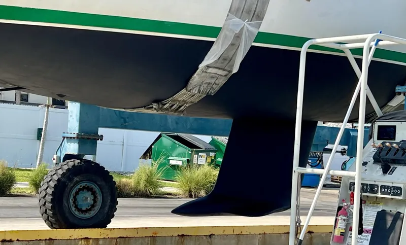 Slide: The Image of 1995 Beneteau First 42s7 sailboat keel in dry dock, with maintenance equipment nearby. - 29