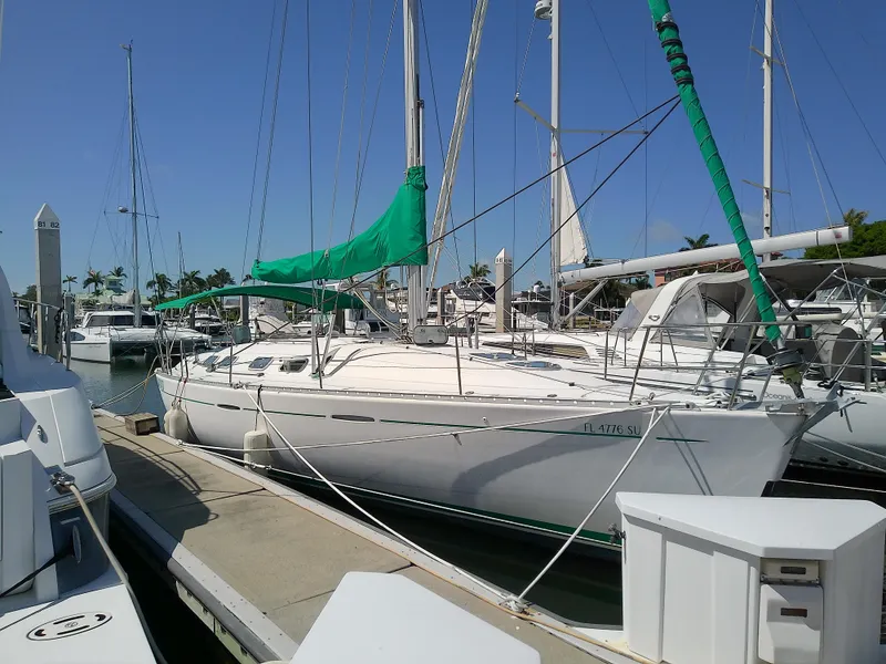 Slide: The Image of 1995 Beneteau First 42s7 sailboat docked at marina under clear blue sky. - 3