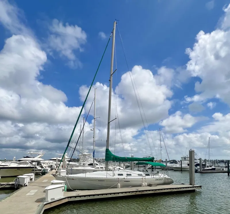Slide: The Image of 1995 Beneteau First 42s7 sailboat docked at marina under blue sky. - 30