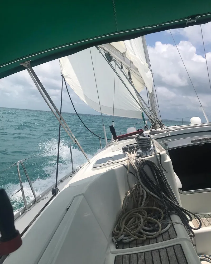 Slide: The Image of Sailing on a 1995 Beneteau First 42s7 yacht in open sea under clear skies. - 33