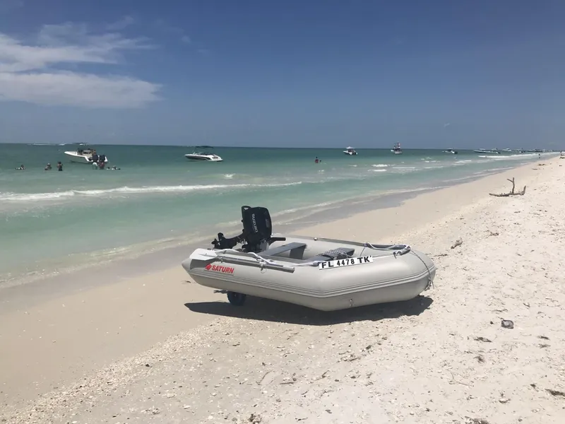 Slide: The Image of Inflatable boat on sandy beach with ocean view, Beneteau First 42s7, 1995 model. - 37
