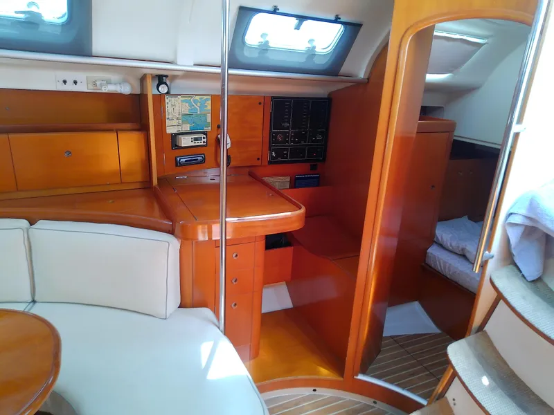 Slide: The Image of Interior of 1995 Beneteau First 42s7 yacht with wood finish and seating area. - 43