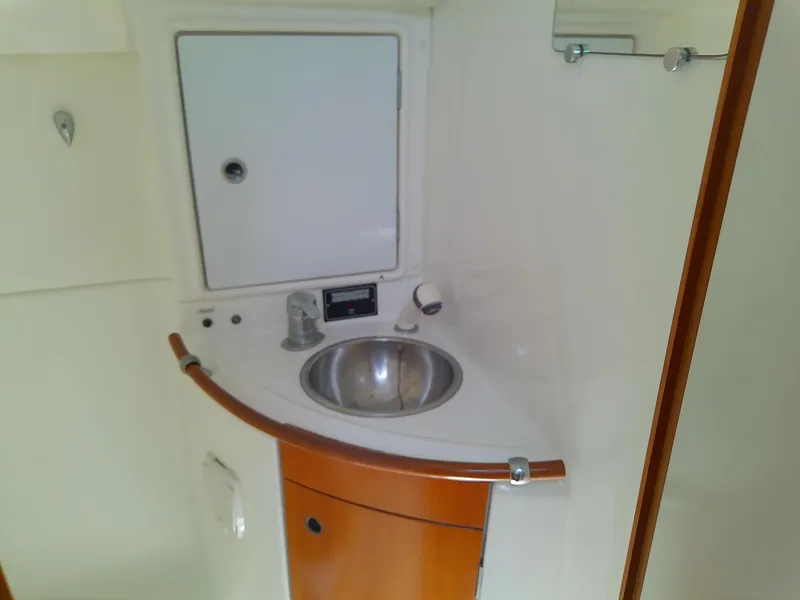 Slide: The Image of Compact bathroom sink area in a 1995 Beneteau First 42s7 yacht. - 49
