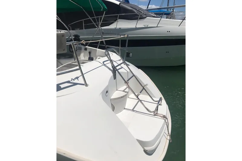 Slide: The Image of Beneteau First 42s7 sailboat, 1995 model, docked with visible ladder and railing. - 6