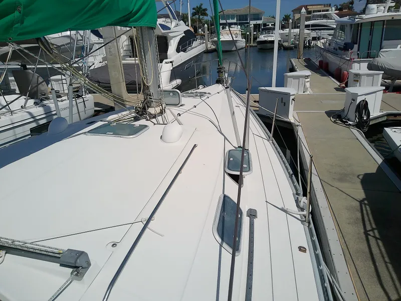 Slide: The Image of 1995 Beneteau First 42s7 sailboat docked at marina, showcasing deck and rigging. - 9