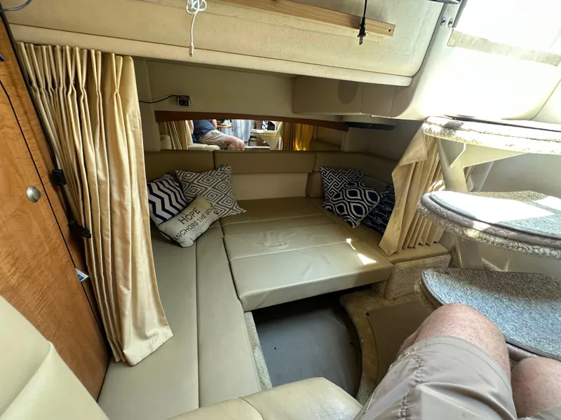 Slide: The Image of Interior of 2006 Sea Ray 320 Sundancer with beige seating and decorative pillows. - 15