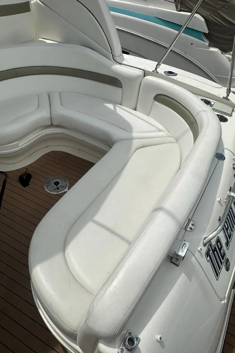 Slide: The Image of 2006 Sea Ray 320 Sundancer boat with white leather seating and wooden deck. - 16