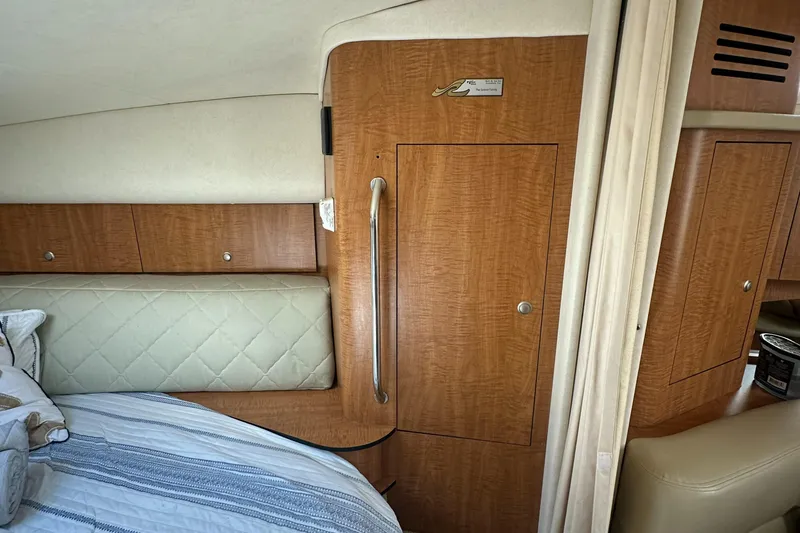 Slide: The Image of Interior cabin of 2006 Sea Ray 320 Sundancer with wood paneling and bedding. - 20