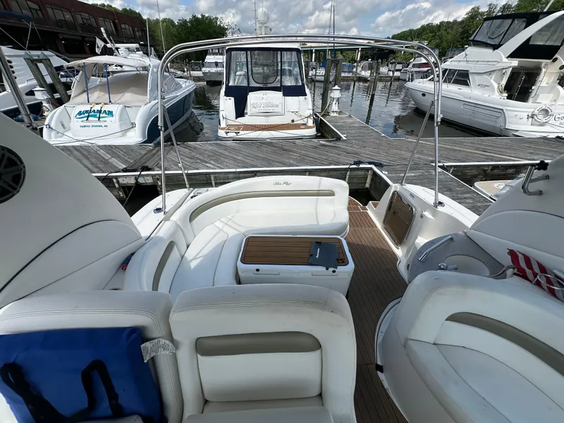 Slide: The Image of 2006 Sea Ray 320 Sundancer at marina, featuring spacious seating and elegant design. - 4