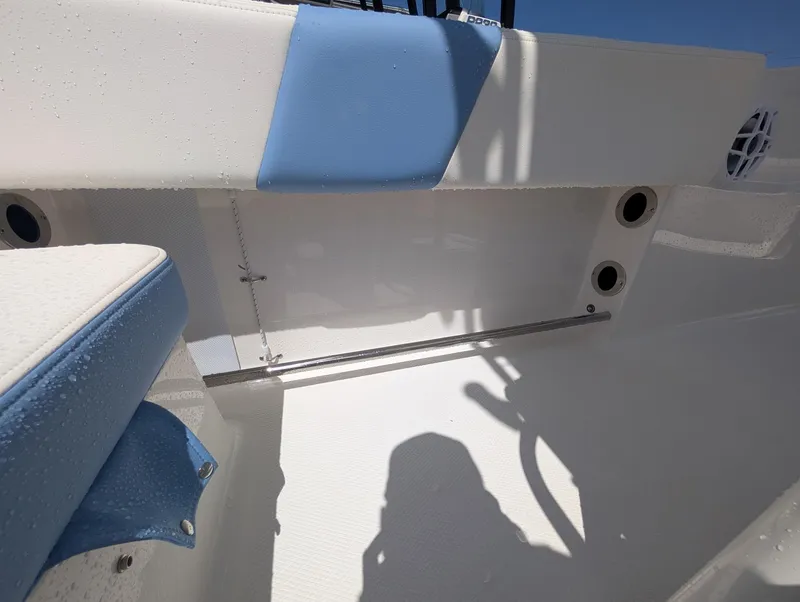 Slide: The Image of 2025 Robalo R202 Explorer boat interior with blue and white seating, showcasing sleek design. - 10