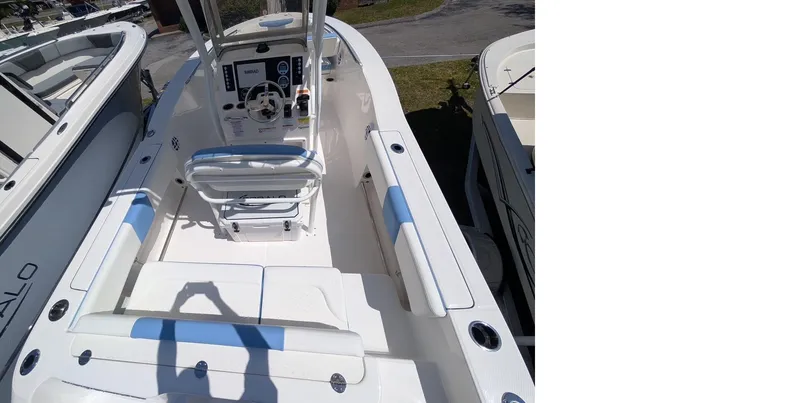 Slide: The Image of 2025 Robalo R202 Explorer boat interior with seating and control console. - 11