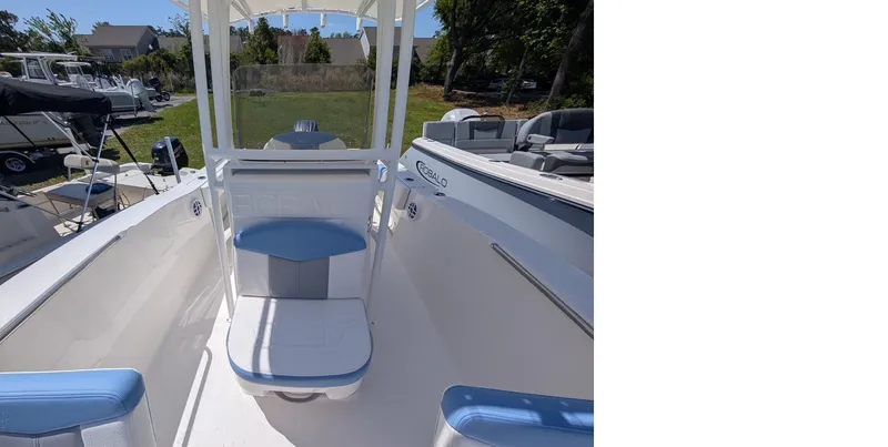 Slide: The Image of 2025 Robalo R202 Explorer boat interior with seating and console, displayed outdoors. - 14
