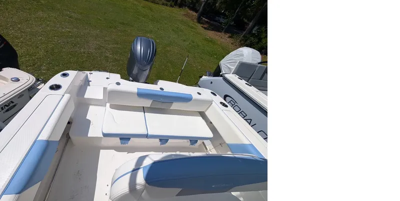 Slide: The Image of 2025 Robalo R202 Explorer boat interior with seating and motor, displayed outdoors. - 5