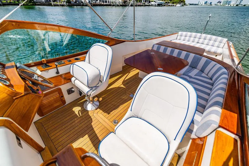 Slide: The Image of 2004 Hinckley Talaria 29 R boat interior with elegant seating and wooden accents. - 10