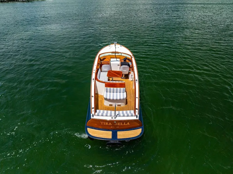 Slide: The Image of 2004 Hinckley Talaria 29 R boat on calm green water, aerial view. - 32