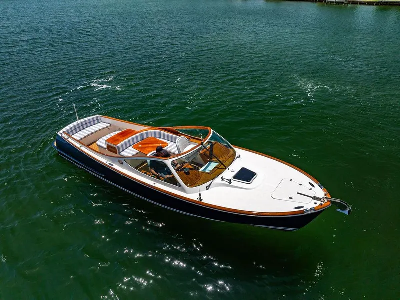 Slide: The Image of 2004 Hinckley Talaria 29 R boat on calm green water. - 34