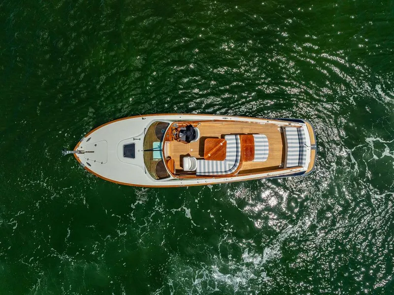 Slide: The Image of Aerial view of 2004 Hinckley Talaria 29 R boat on green water. - 4
