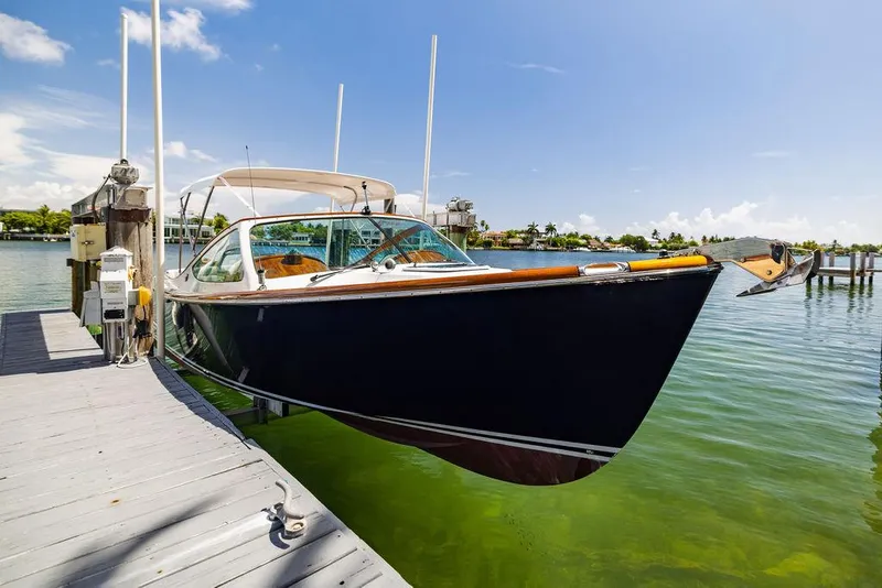 Slide: The Image of 2004 Hinckley Talaria 29 R docked on clear water under blue sky. - 43