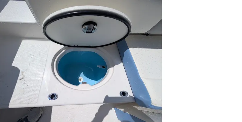 Slide: The Image of 2025 Robalo R202 Explorer boat livewell with open lid, showcasing interior. - 4