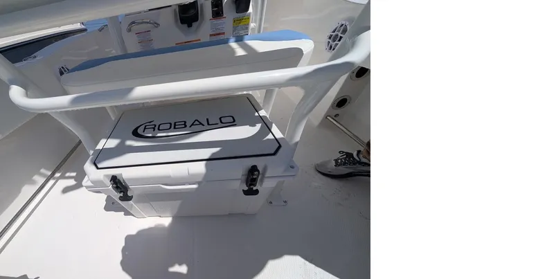 Slide: The Image of 2025 Robalo R202 Explorer boat interior with storage compartment and cooler. - 6